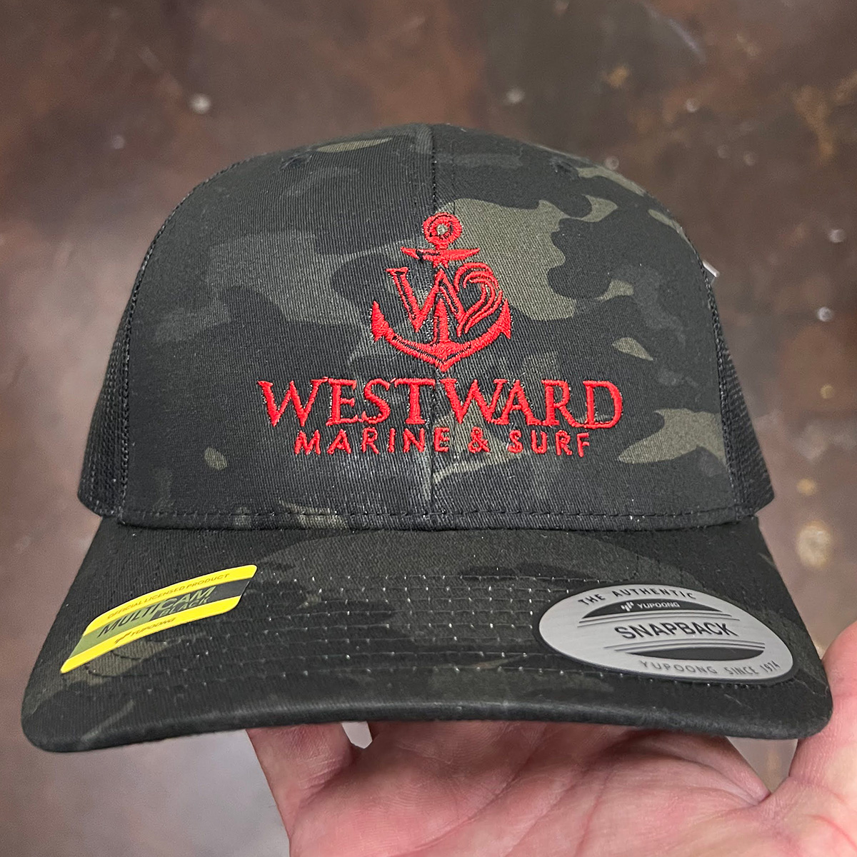 Camo Yupoong retro trucker hat with embroidered logo