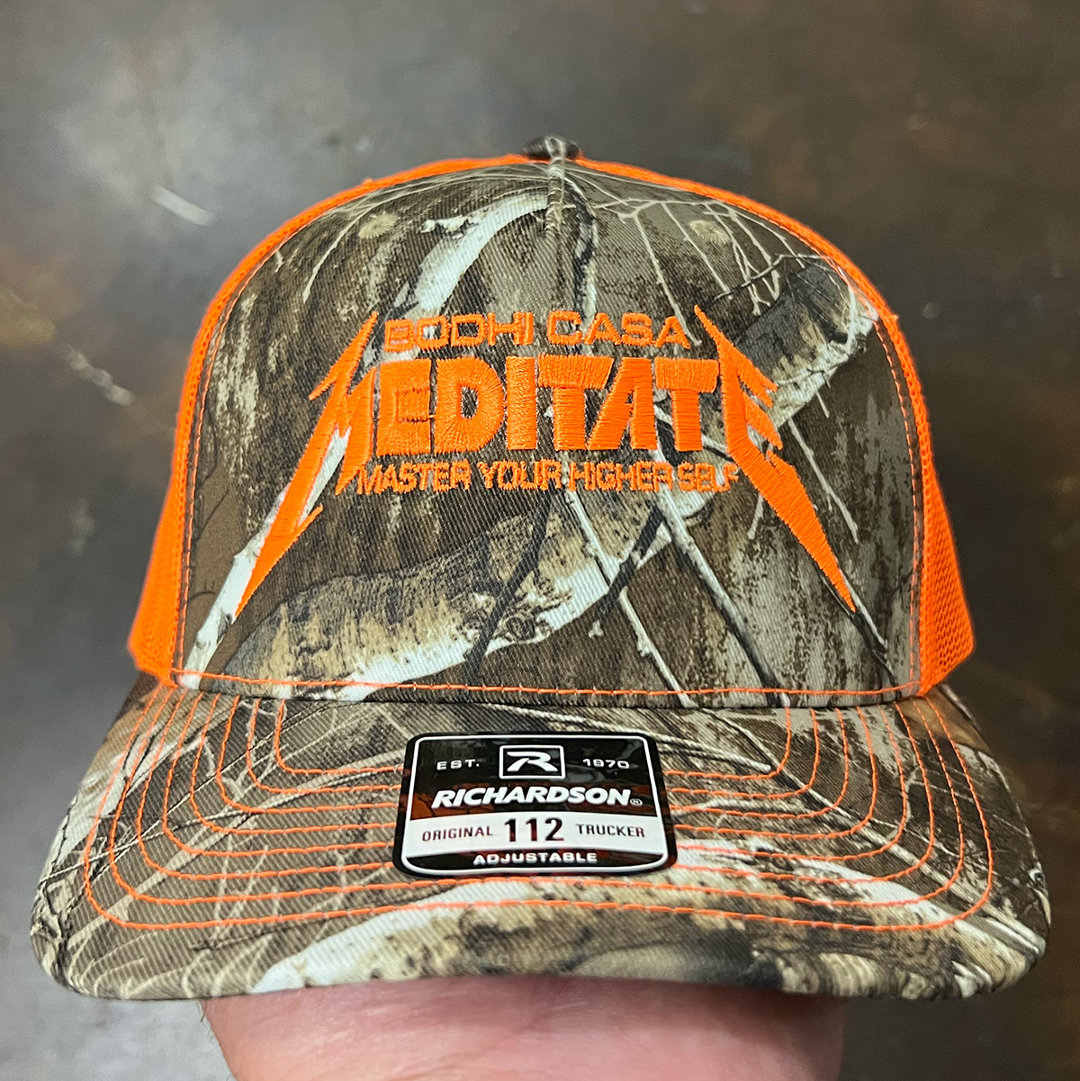 Richardson Blaze orange camo trucker hat with embroidered logo