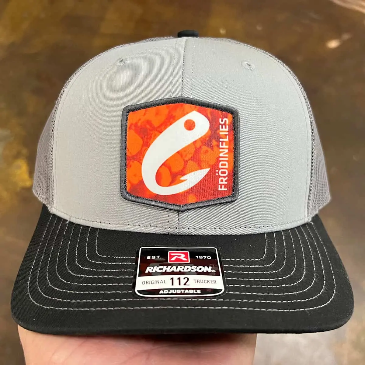 grey custom trucker hat with sublimated patch logo
