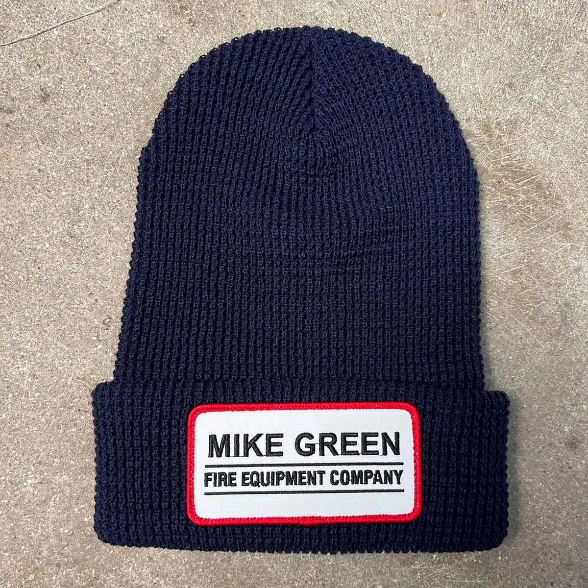 Embroidered patch sewn onto a cuffed beanie
