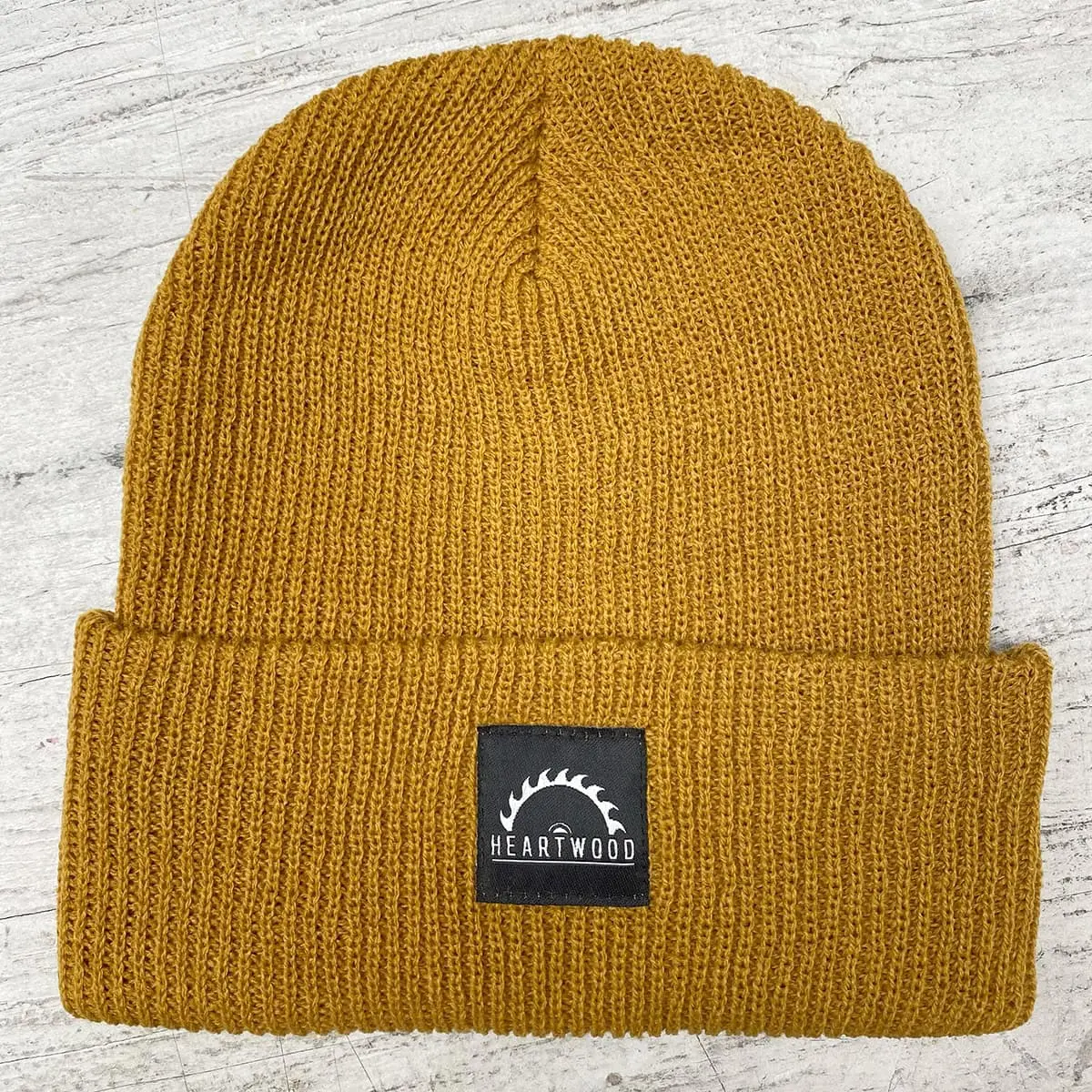 Mustard cuffed beanie with woven label for Heartwood