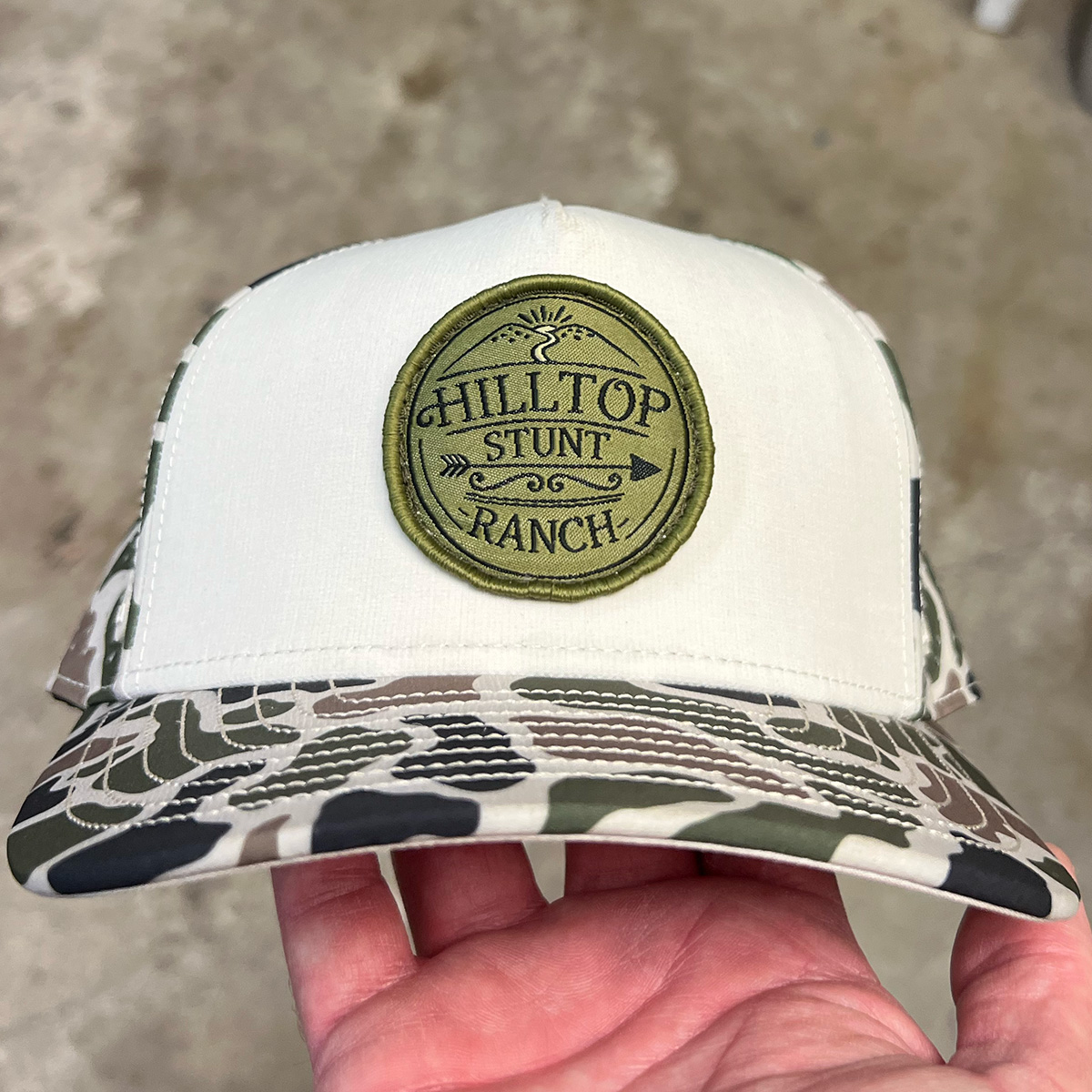 Camo trucker hat with custom logo patch