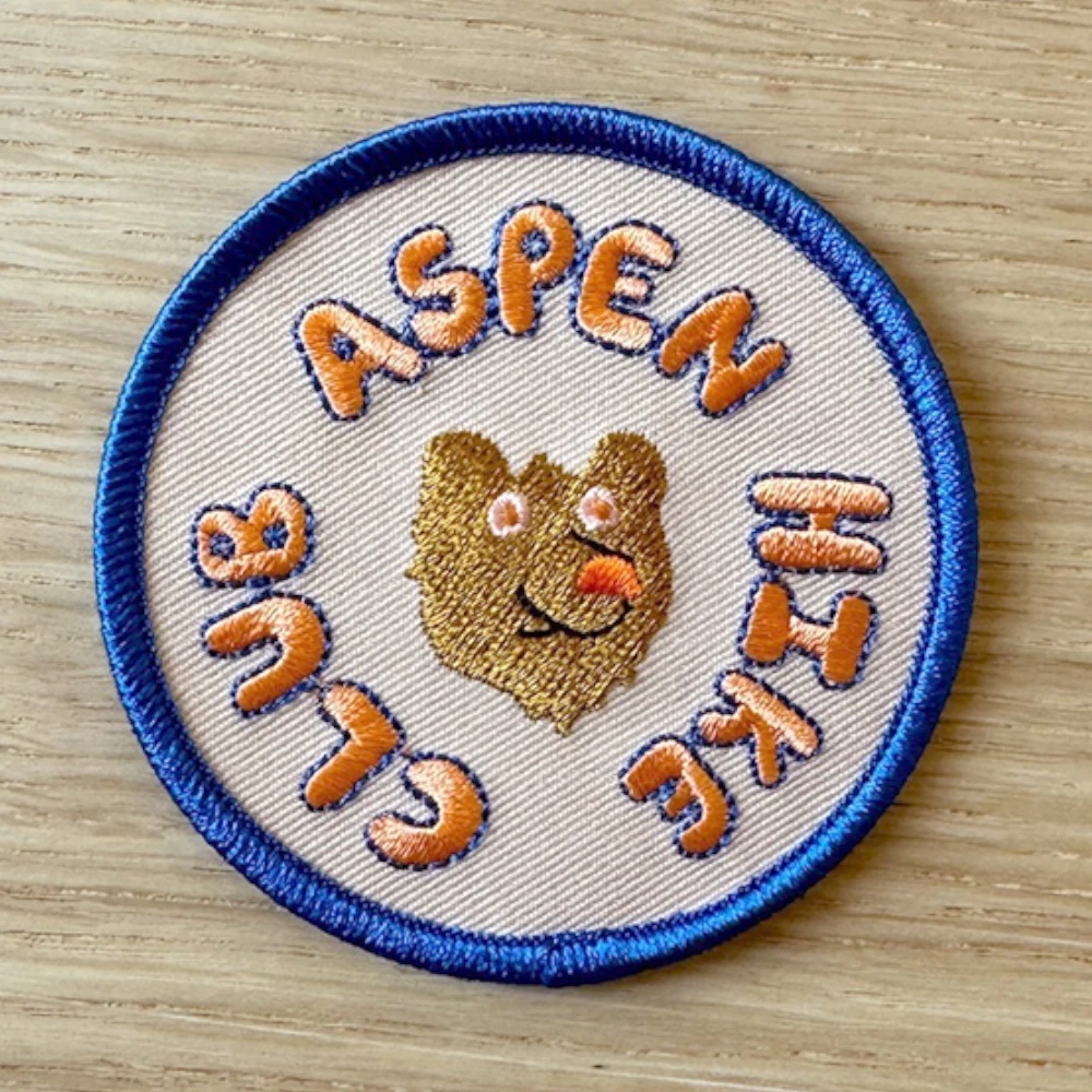 circle embroidered patch with merrow border and crest design