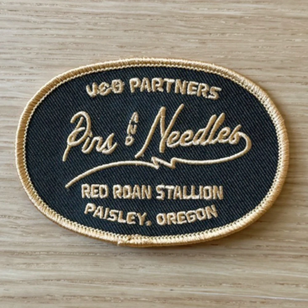 oval embroidered patch with brand logo