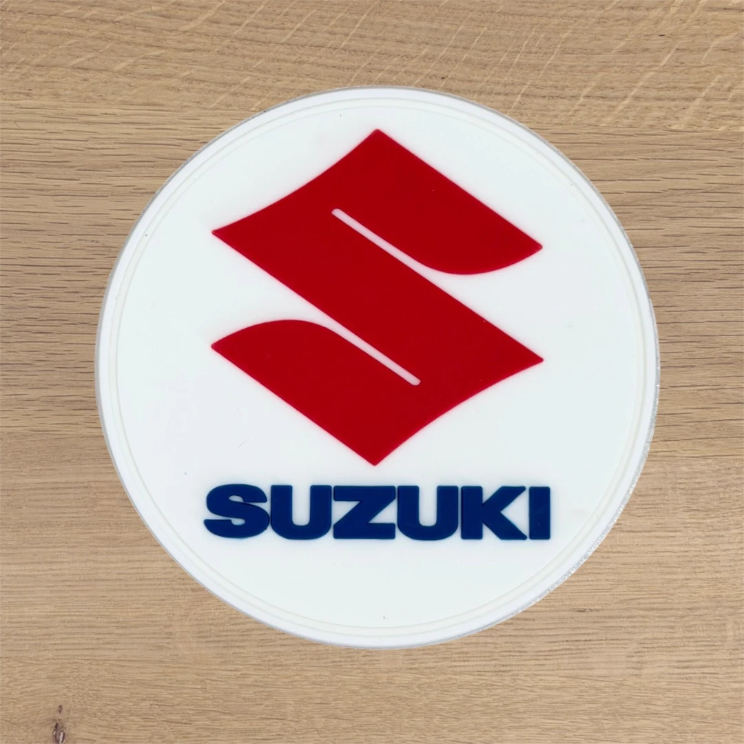 white PVC circle patch with red and blue automotive logo
