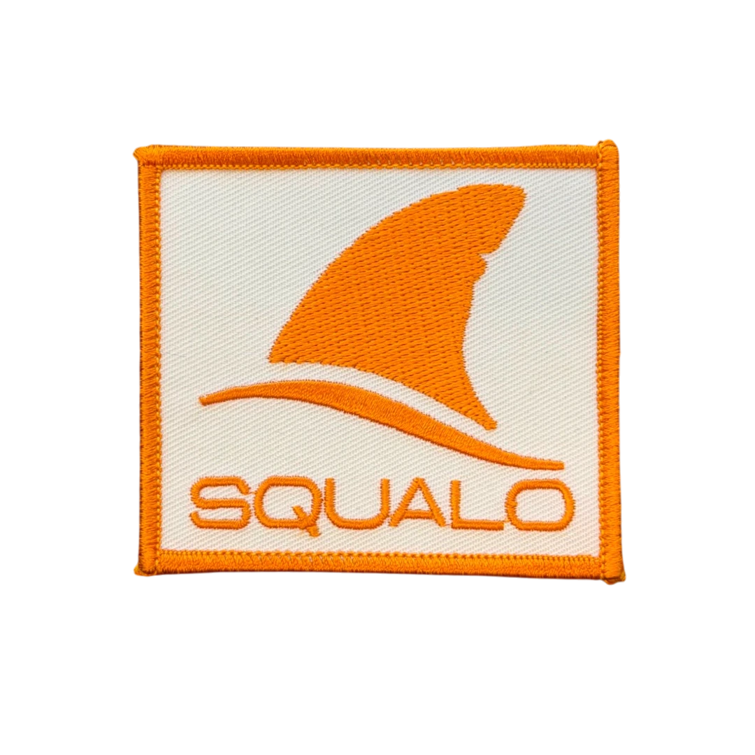 white square embroidered patch with orange shark fin logo