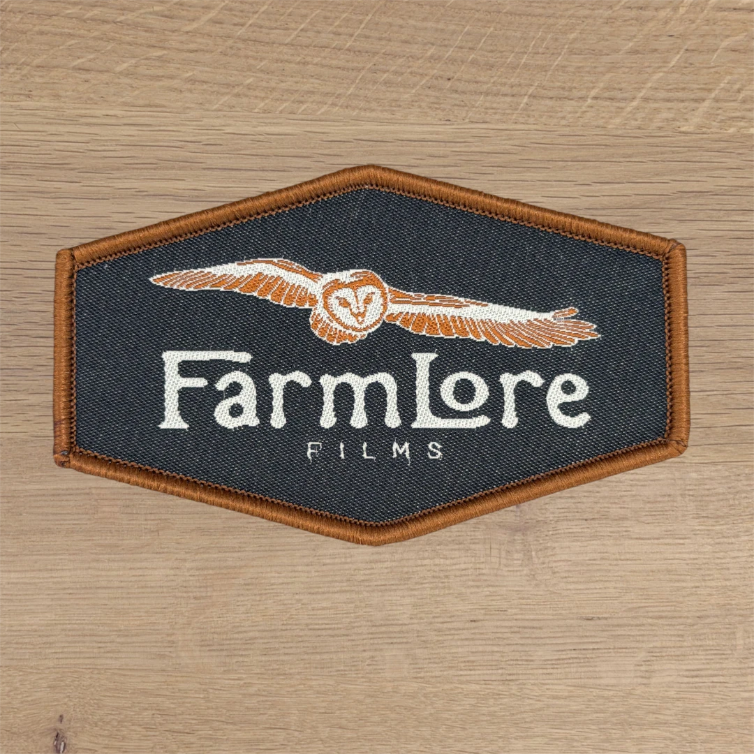 navy hexagon woven patch with owl logo and brown merrow border