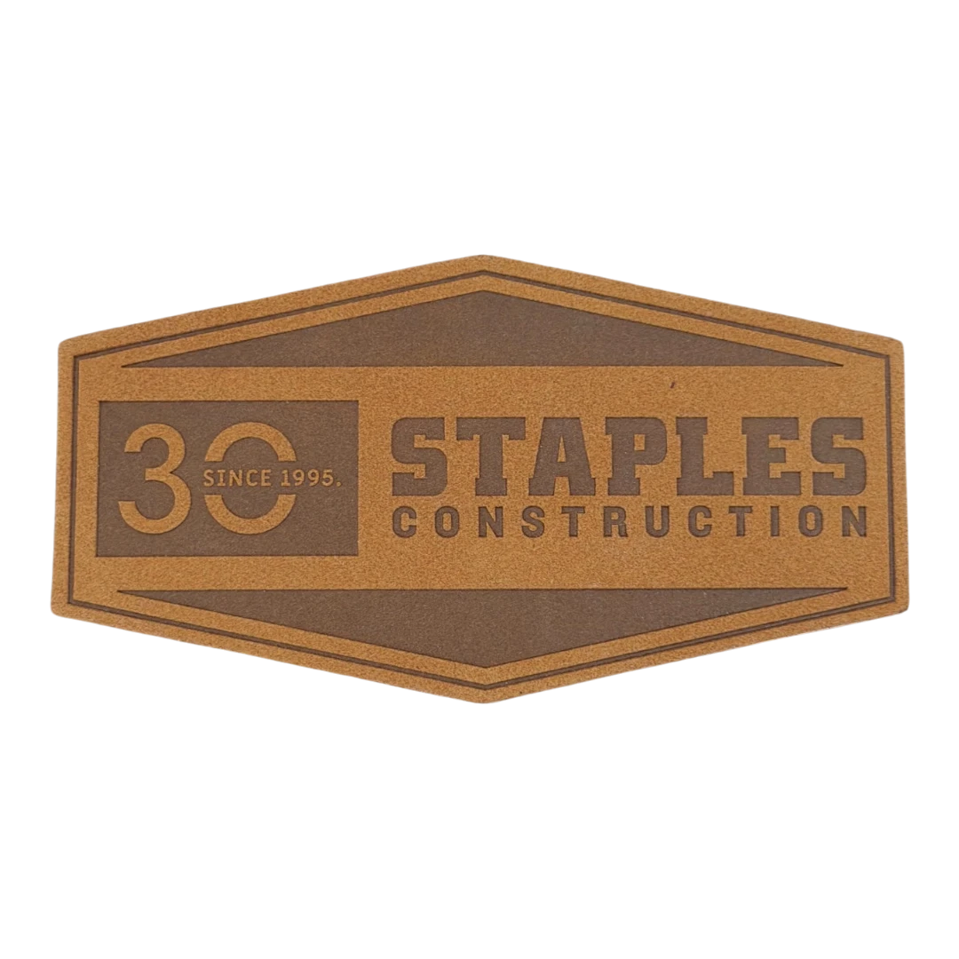 tan hexagon laser engraved leather patch with construction company logo