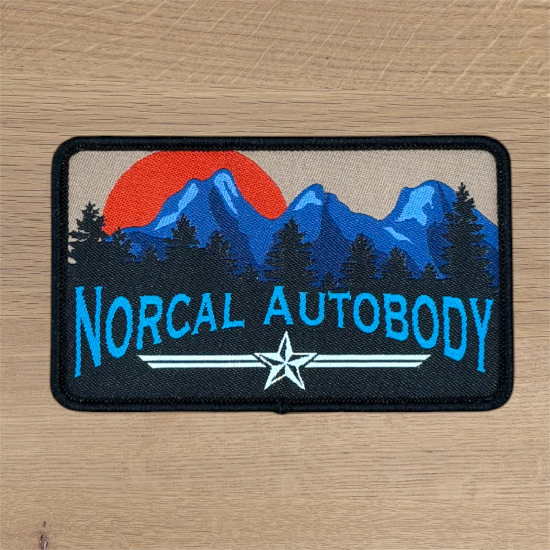 rectangle woven patch with mountain sunset scene and blue lettering