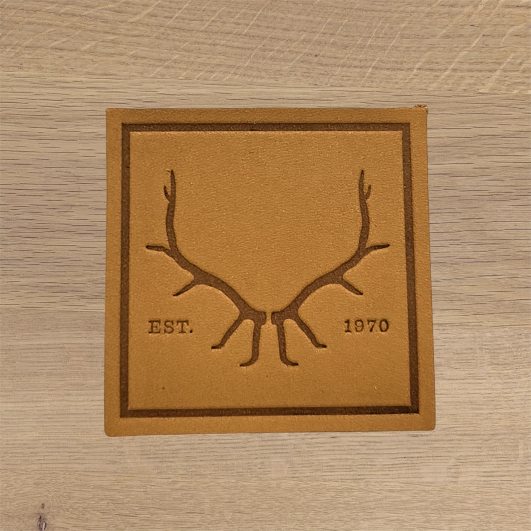 tan square leather patch with engraved antlers design