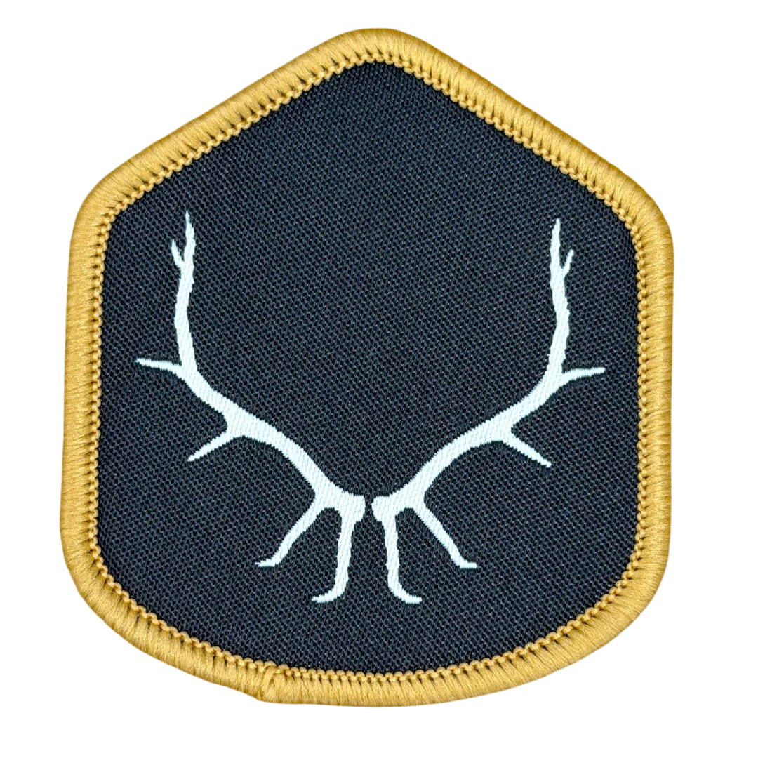 shield woven patch with white antler design and gold border